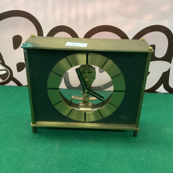 Vintage Kundo electronic clock with black case and circular dial.