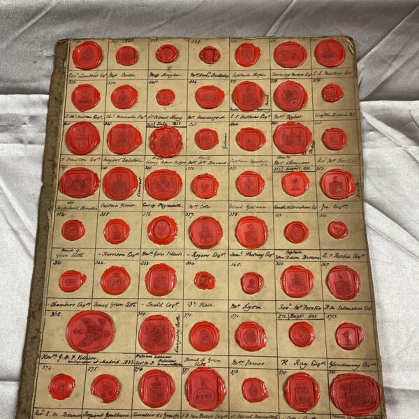 Close-up of a collection of vintage wax seals with various designs.