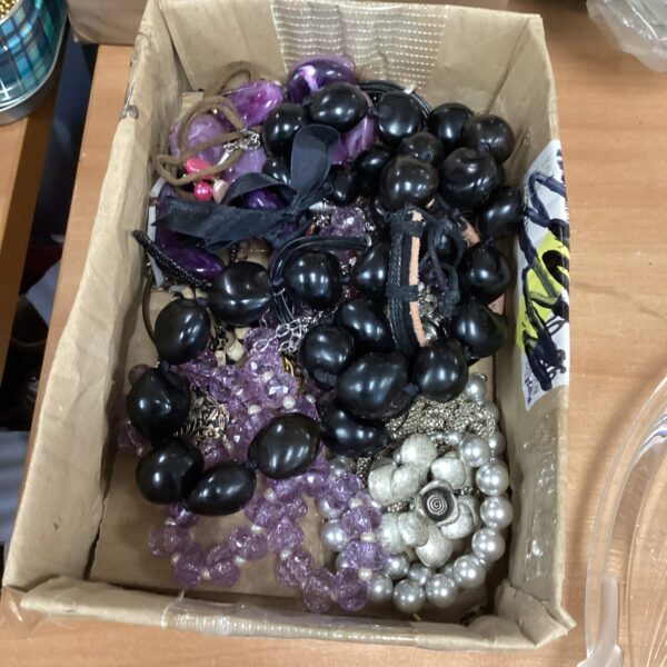 Assortment of vintage costume jewellery including beaded necklaces.