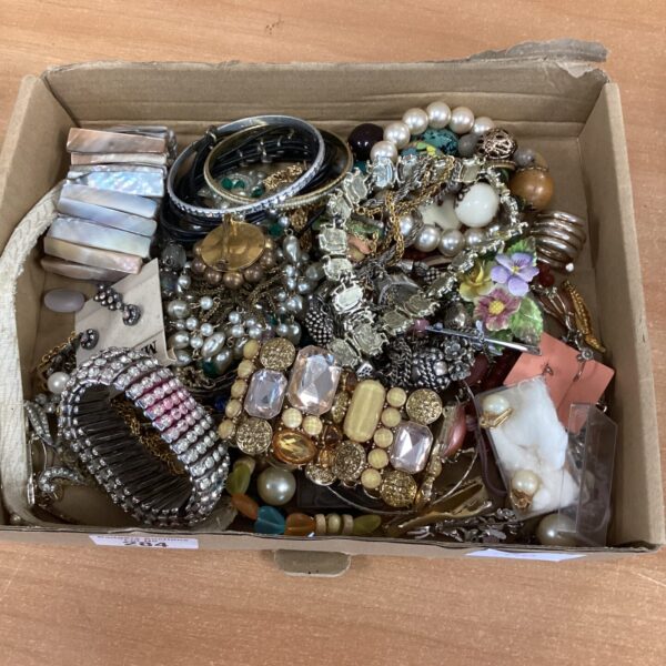 Assortment of vintage costume jewellery including necklaces and brooches.