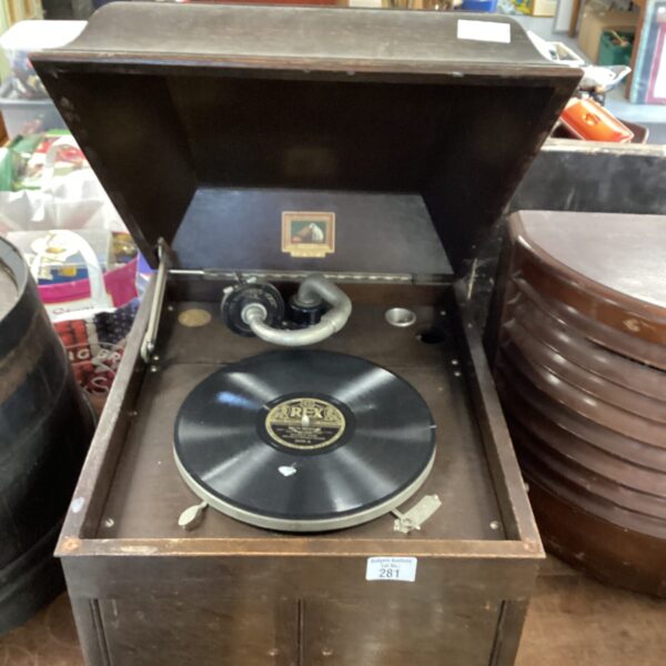 Vintage HMV gramophone with wooden cabinet and turntable.