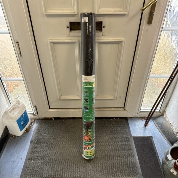 Used Netlon weed membrane roll for garden weed control.
