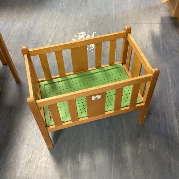 Vintage wooden dolls cot with slatted sides.