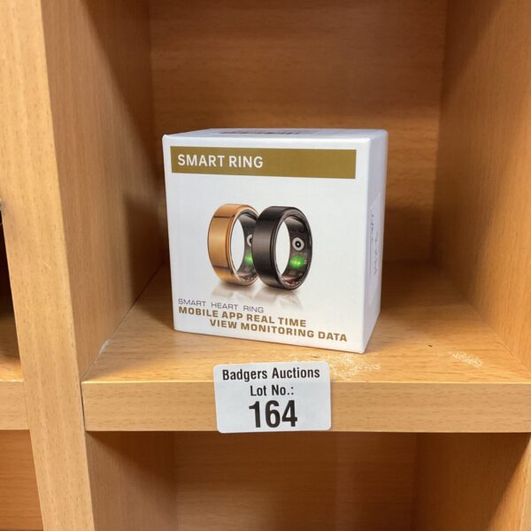 Polished metal smart ring for heart rate and fitness tracking.