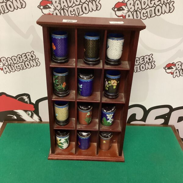 Vintage wooden rack displaying a collection of colourful cloisonne vases.