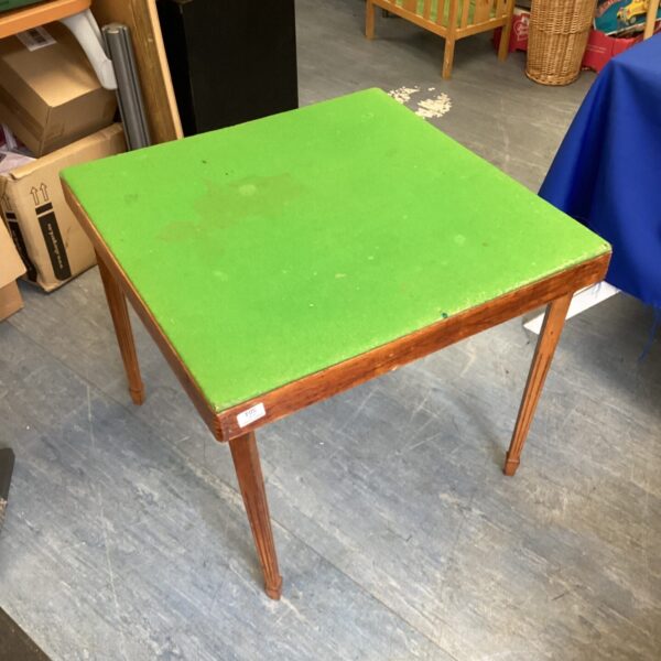 Vintage green felt folding card table for game nights.