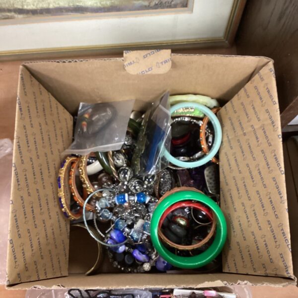 Assortment of vintage costume jewellery including necklaces and brooches.