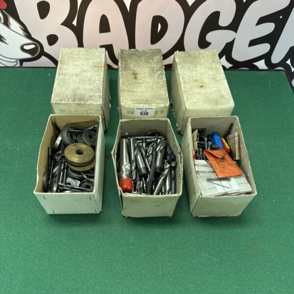 Three boxes of engineering tool attachments for workshop use.