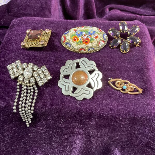 Vintage brooch lot featuring millifiori and floral designs.