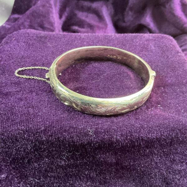 Antique Chester silver hinged bracelet with embossed floral design.