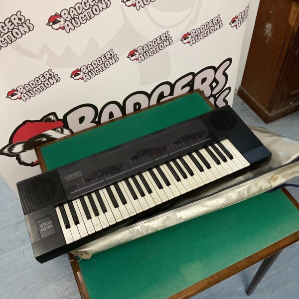 Vintage Lowrey Micro Genie electric keyboard with carry case.