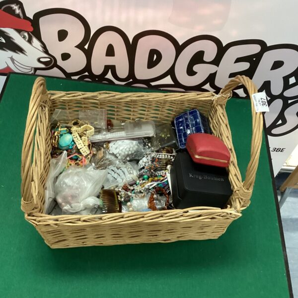 Woven basket filled with a colourful assortment of costume jewellery.