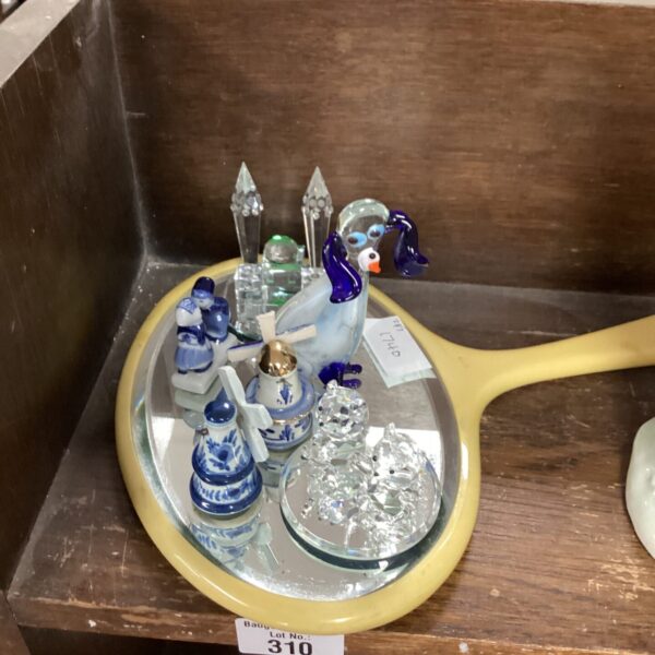 Miniature porcelain ornament collection on a mirror base.