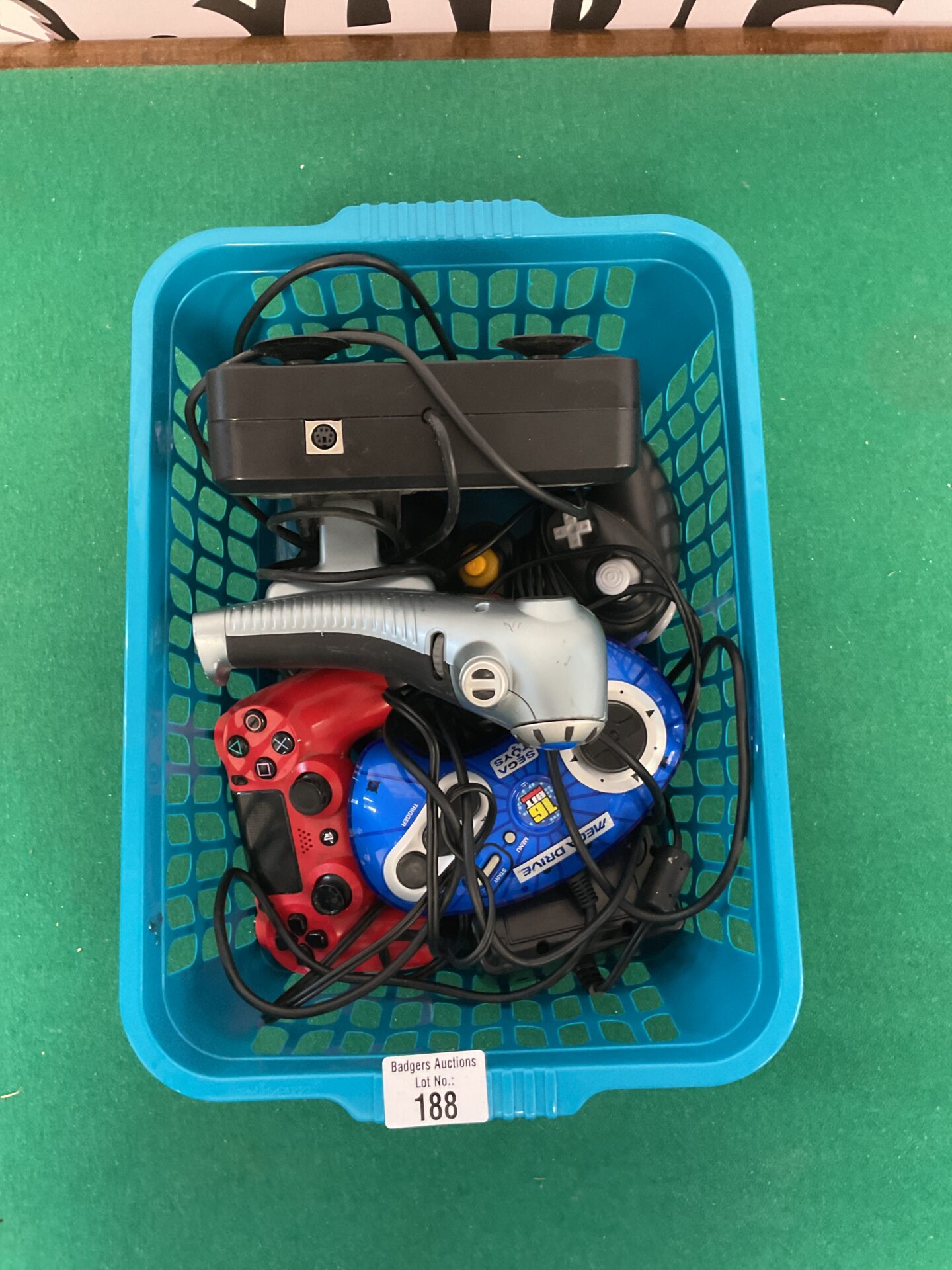 188 Box of electronics including two sony ps4 remotes, sega megadrive and saitek x52