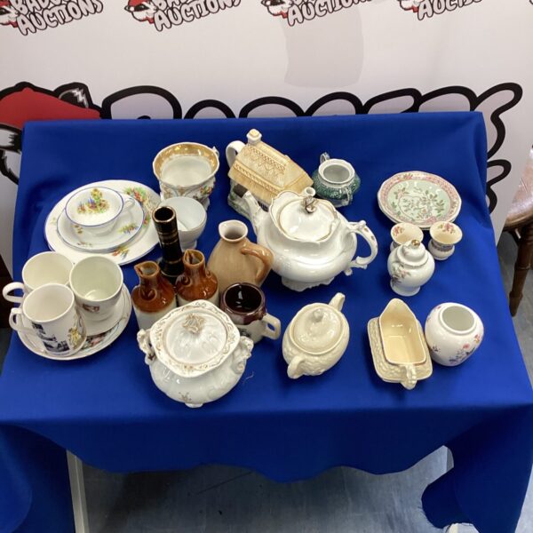 Vintage china and ceramic collection with a novelty teapot and plates.