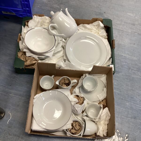 White porcelain dinner service set with plates and teacups.