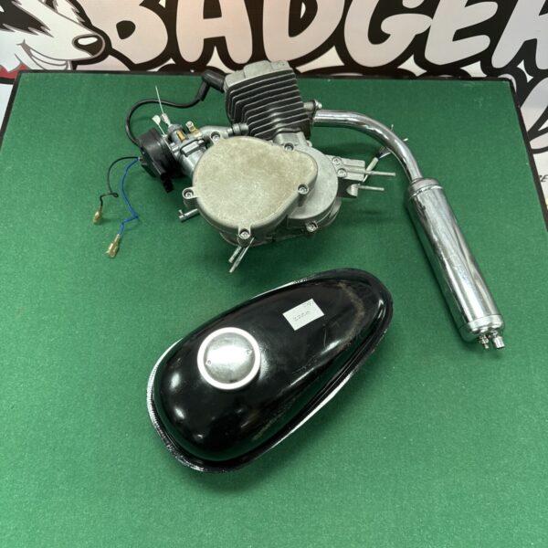 Untested mini moto engine with exhaust and fuel tank for projects.