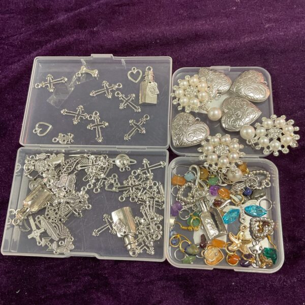 Mixed lot of jewellery making charms and components in trays.