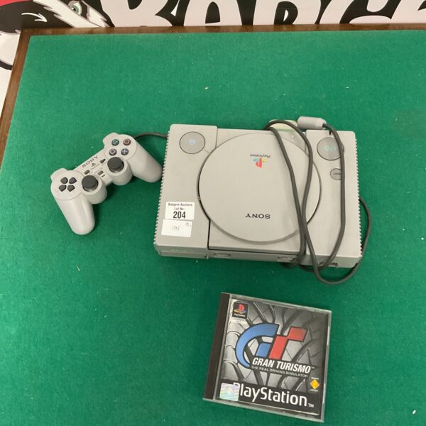 Vintage Sony PlayStation 1 console with Gran Turismo game.