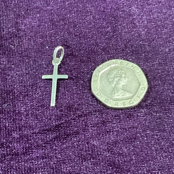 Close-up of a vintage silver cross pendant.