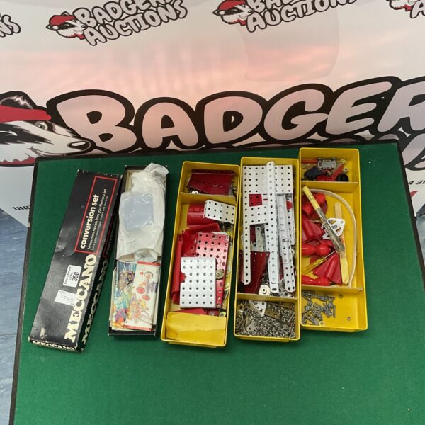 Vintage Meccano construction set with metal components in a box.