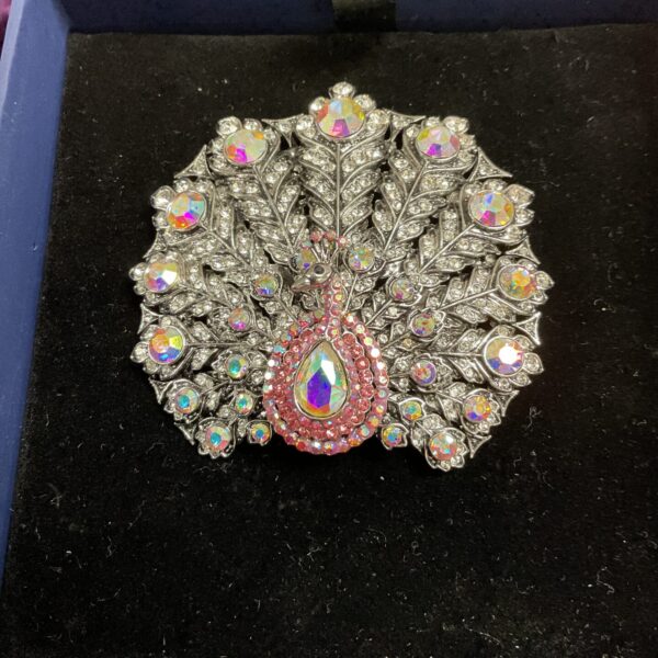 Iridescent Butler and Wilson peacock brooch, detailed crystal design.