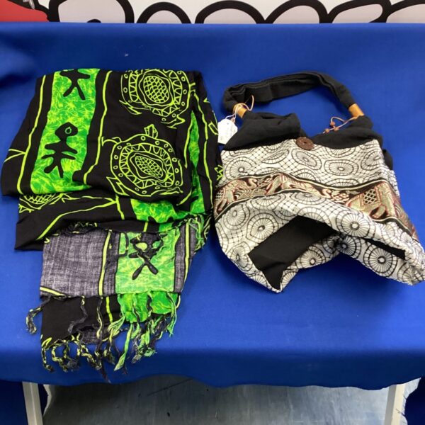 Vibrant silk sarong and beach bag set with green and black pattern.