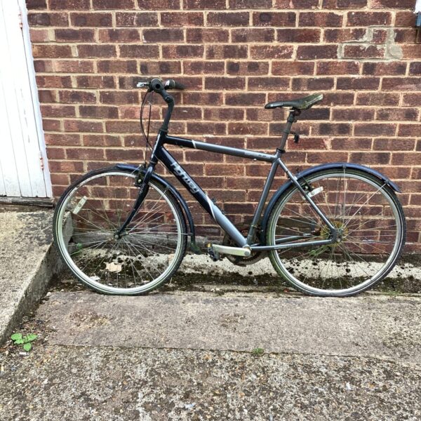 Side view of a used Apollo Highway bike with mudguards.