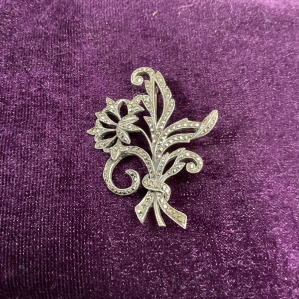 Vintage silver marcasite brooch with floral design.