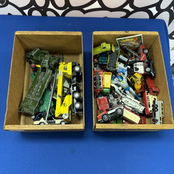 Assorted diecast toy cars and trucks in a tray.