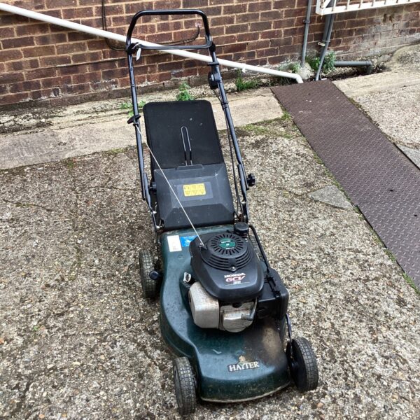 Vintage Hayter Motif 48 lawn mower in a garden setting.
