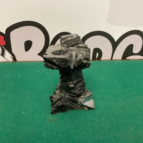 Dark metallic gothic candle holder with textured detailing.