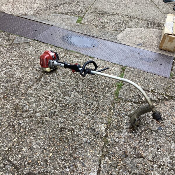 Cobra petrol strimmer for garden maintenance and landscaping.