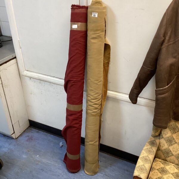 Two rolls of red and tan fabric, ideal for crafting.