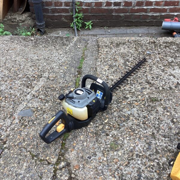 Used Titan petrol hedge cutter for garden landscaping.