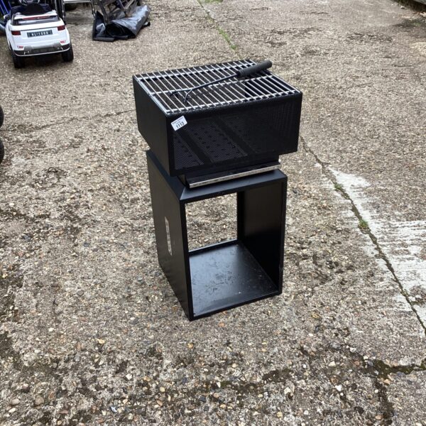 Metal fire grate BBQ for outdoor cooking and camping.
