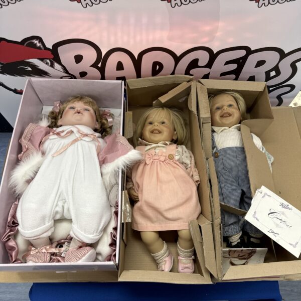 Close-up of a collector doll from a lot of three.
