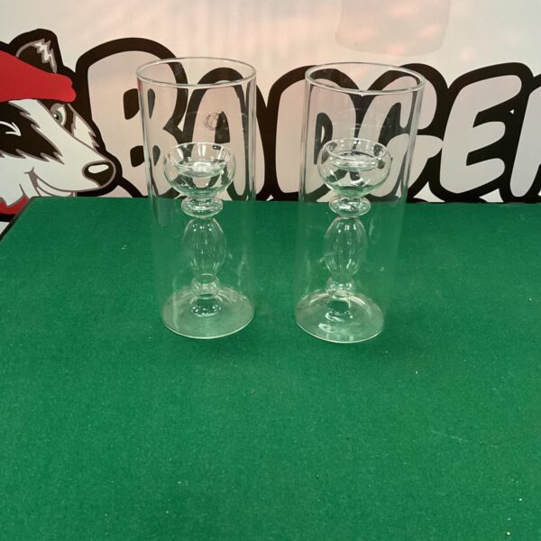 Pair of clear glass tealight holders for warm ambiance.