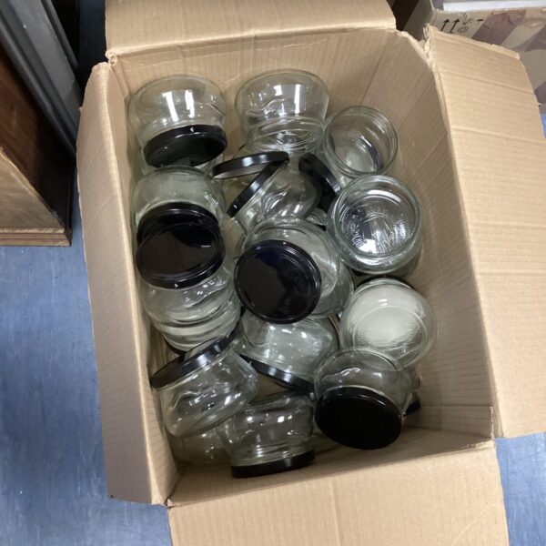 Lot of glass jars with lids for kitchen storage.