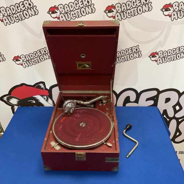 Vintage HMV gramophone with wooden cabinet and metal horn.