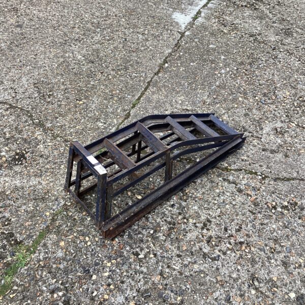 Set of sturdy metal car ramps for vehicle maintenance.