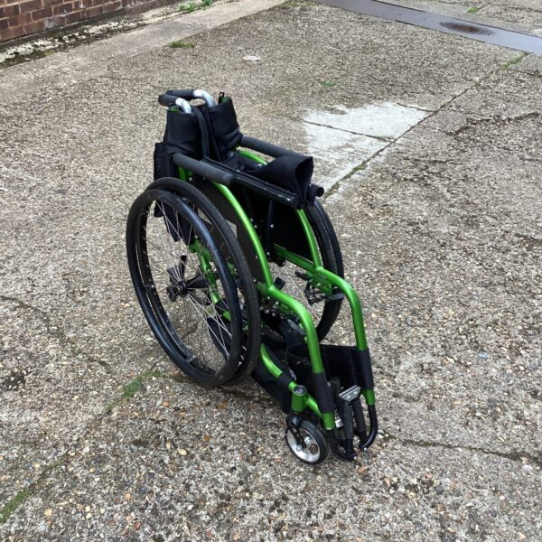 Blue folding wheelchair in used condition, ideal for mobility assistance.
