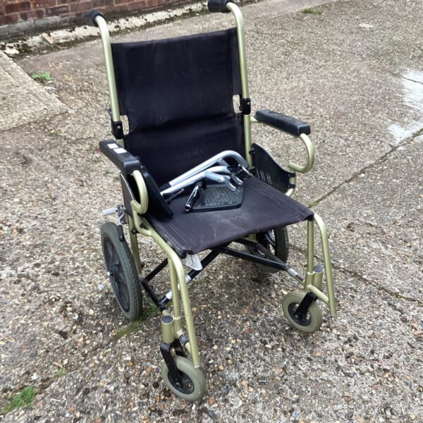 Side view of a used Karma folding wheelchair.