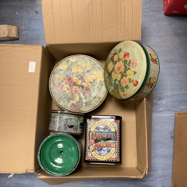Collection of colourful vintage tins for storage and display.