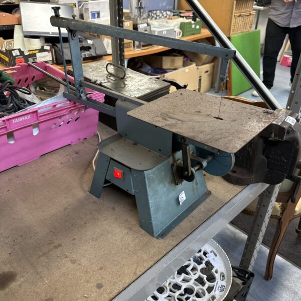Vintage fretsaw with Harvalux motor, antique woodworking tool.