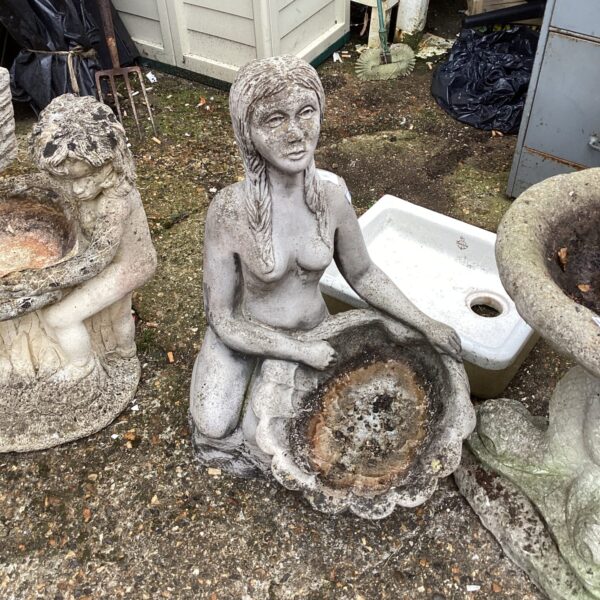 Detailed stone effect bird bath with a kneeling lady statue.