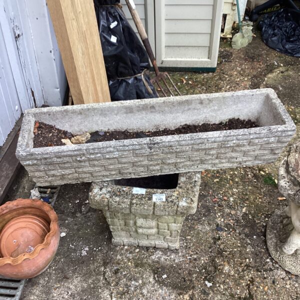Long rectangular stone effect garden planter for outdoor display.