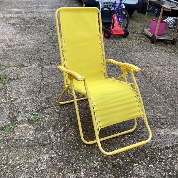 Brightly coloured sun lounger in a garden setting.