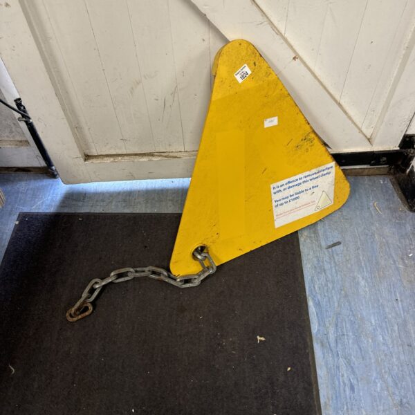 Front view of a yellow DVLA wheel clamp.