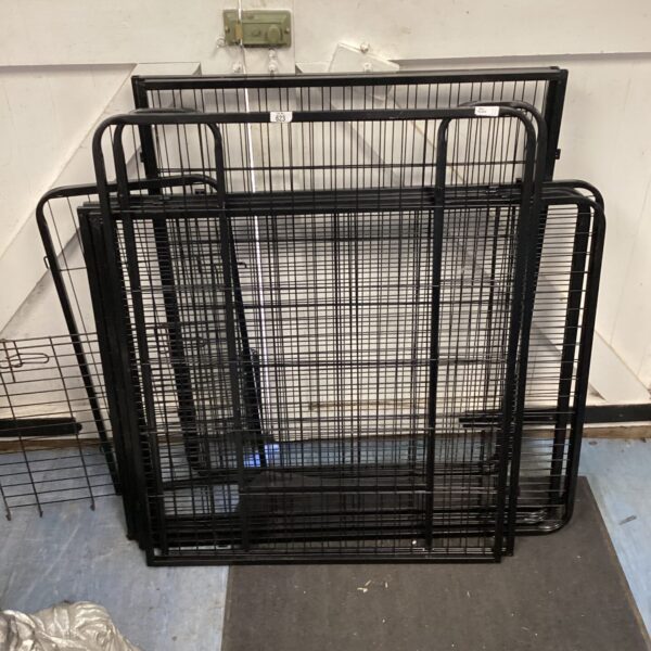 Side view of a metal dog playpen with welded bars.